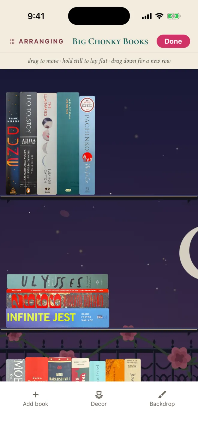 ShelfLife shelf in arrange mode with the hint drag to move, hold still to lay flat, drag down for a new row, and Add book, Decor, and Backdrop tools